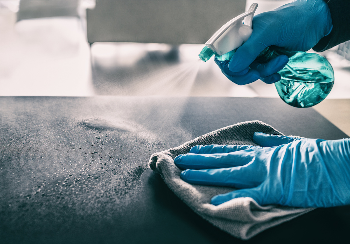 Surface Sanitizing Against Covid 19 Outbreak. Home Cleaning Spraying Antibacterial Spray Bottle Disinfecting Against Coronavirus Wearing Nitrile Gloves. Sanitize Hospital Surfaces Prevention.