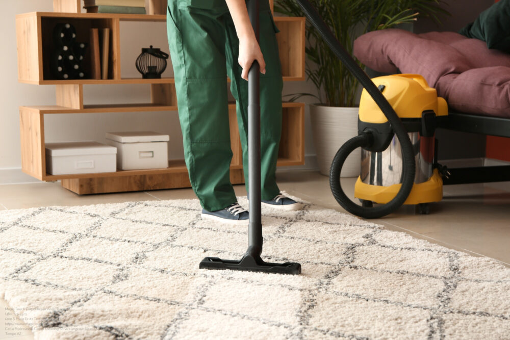Worker Cleaning Carpet With Hoover